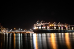 Container ship and dock reflections